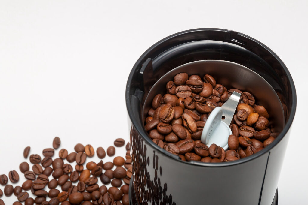 Electric grinder machine with roasted coffee beans